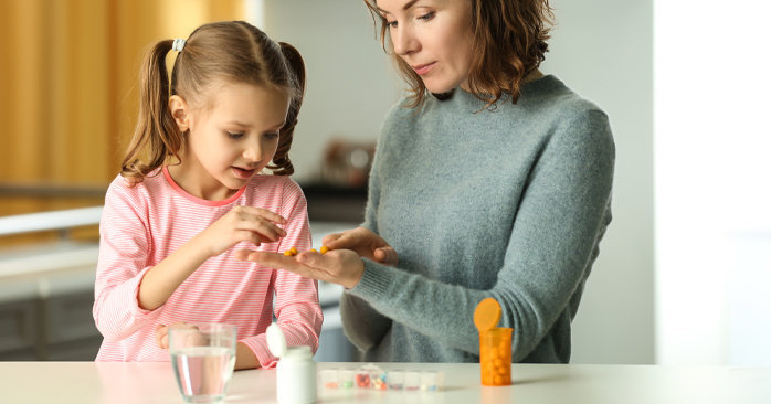 Mother giving her child medication